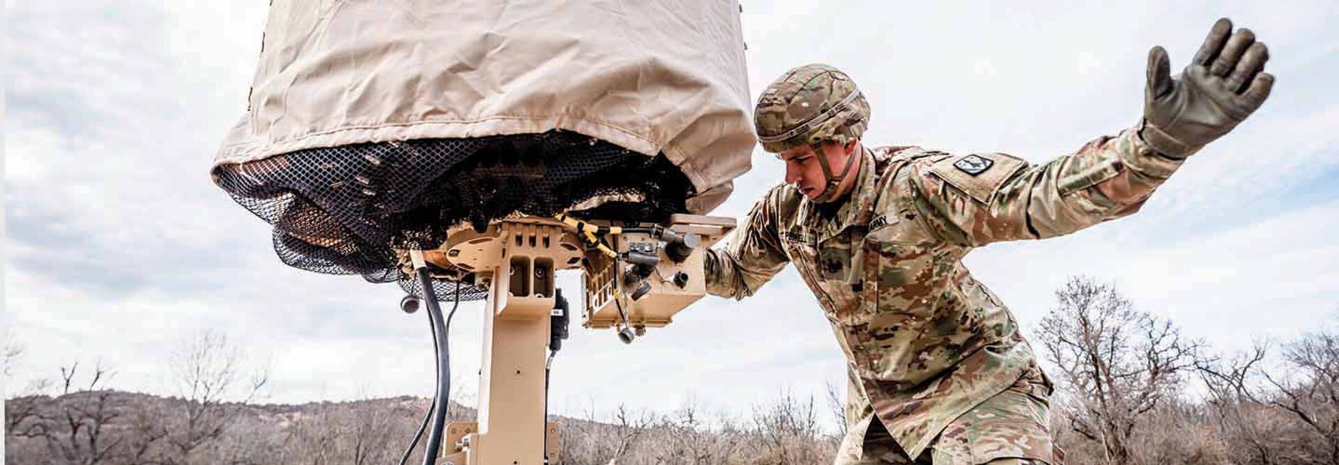 Military member using tech in the field