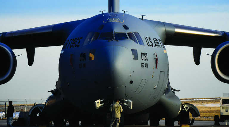 C-17 Globemaster III sits on a flightline; nose points towards camera