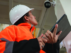 Factory worker inspecting camera